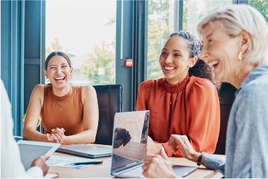 Businesspeople laugh joyfully in a meeting room