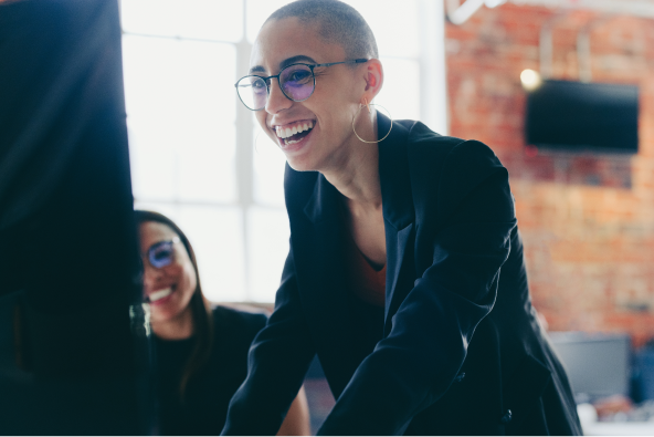 Colleagues work joyfully at a computer