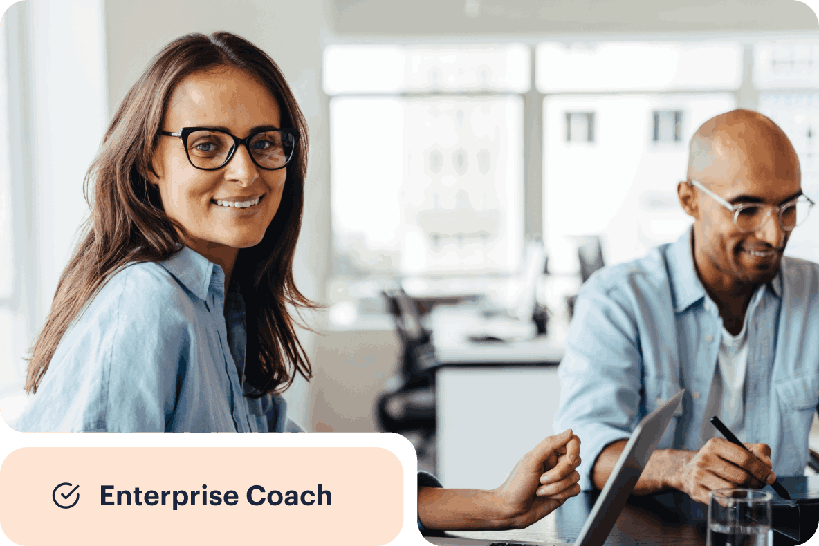 Two professionals at work with the word "Enterprise Coach" in the lower left