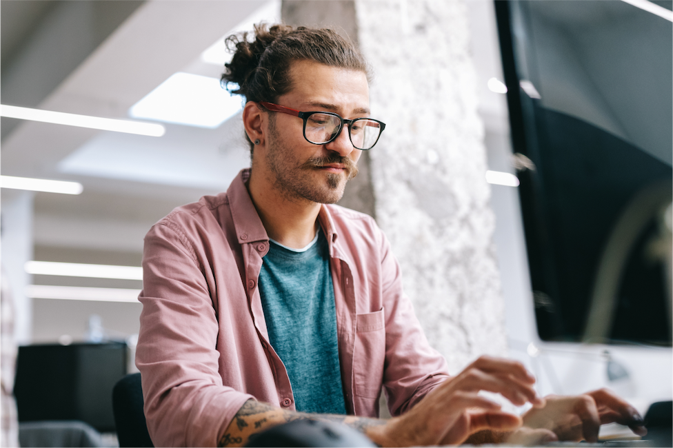 A professional works at a laptop