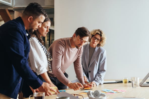 A group of colleagues with sticky notes at a table