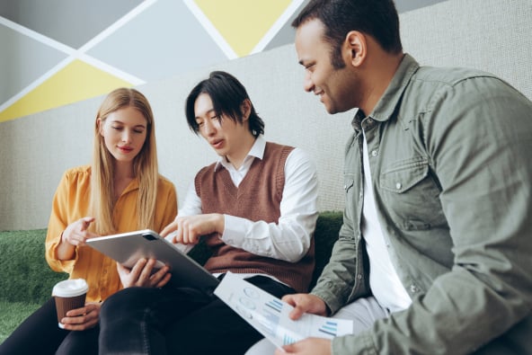 Business professionals in discussion holding a tablet
