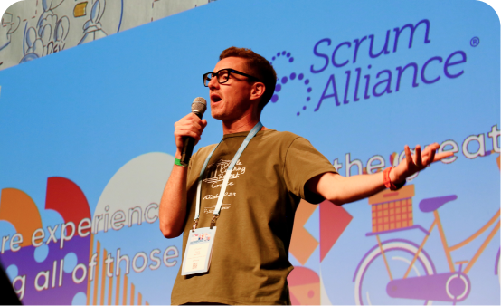 Scrum alliance member speaking on stage