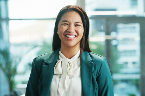 A young professional in a blazer smiles
