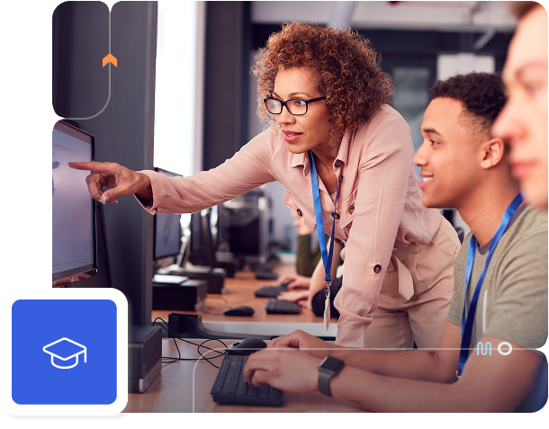 A woman points at a computer monitor