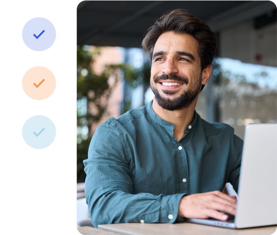 A person smiling and using a laptop