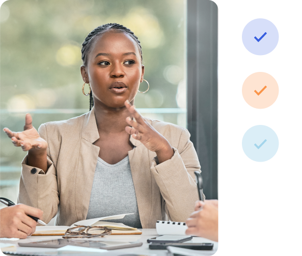 A professional person presents to colleagues at a desk