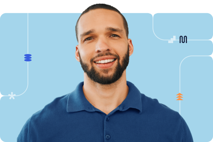 Smiling male professional wearing a blue collared shirt in a light blue background