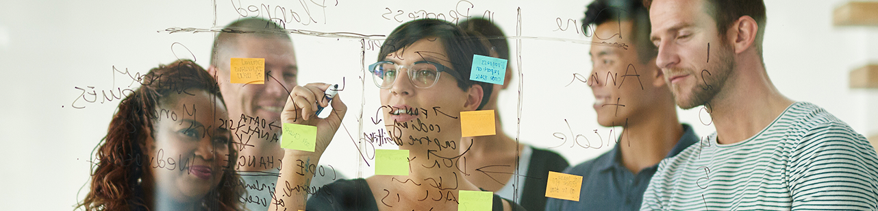 Team of professionals collaborating at a whiteboard
