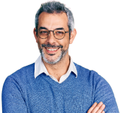 A person in a blue sweater smiling