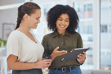 What-is-agile_Getting started with agile Two coworkers view a tablet
